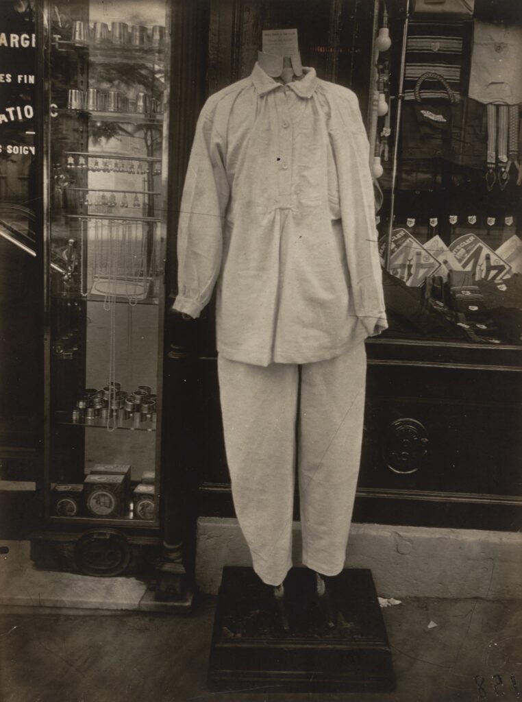 Eugène Atget photograph of a shop window on Avenue des Gobelins, Paris, with a mannequin in a white work suit, 1925 to 1927